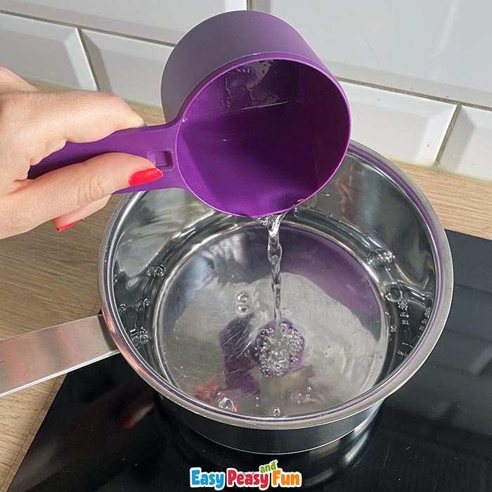 Pouring water into a souce pan