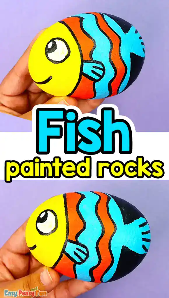 A colorful fish painted rock with orange and blue stripes, a yellow head, and a smiling face held in a hand.