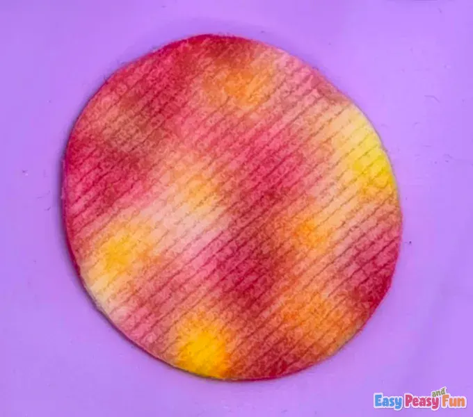 Wet, colorful tie-dye effect visible across the damp cotton surface.