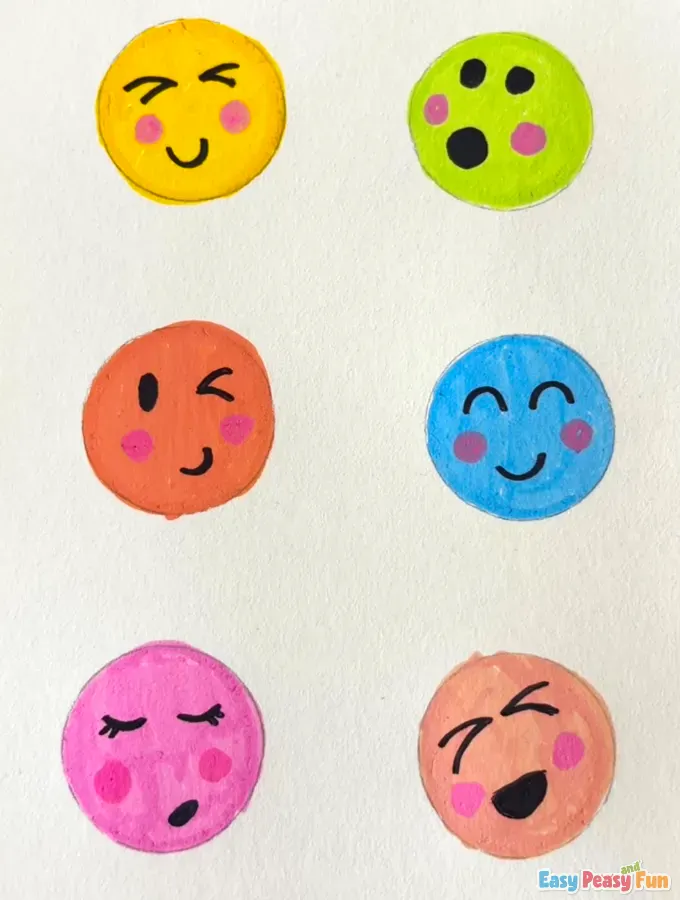 Six different colored emojis displayed on a white surface.