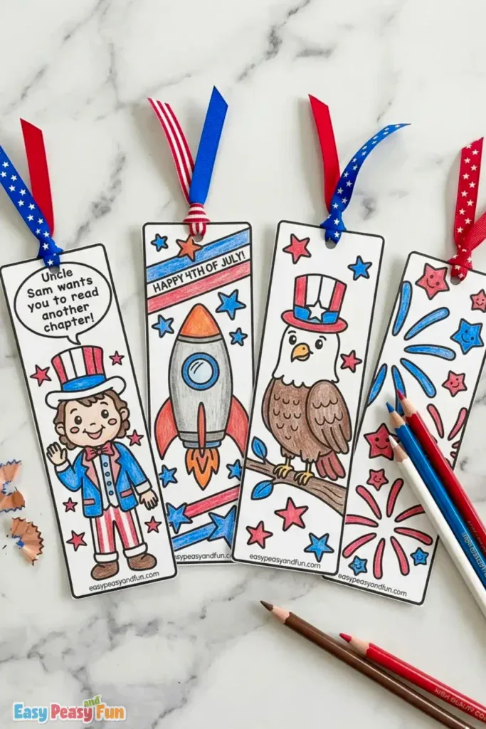 Four completed 4th of July bookmarks with patriotic ribbons, featuring Uncle Sam saying "Uncle Sam wants you to read another chapter.", a rocket, a top-hatted eagle, and fireworks next to colored pencils.