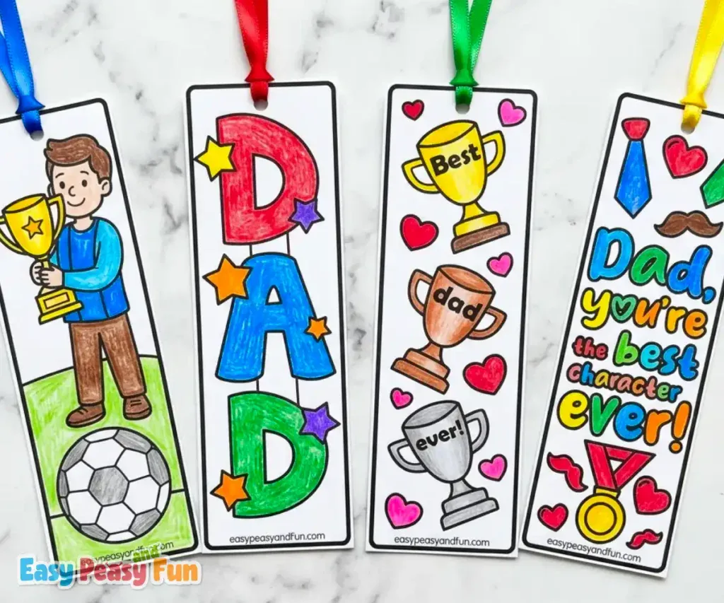 Four colored Father's Day bookmarks with ribbons featuring a soccer dad with trophy, bold DAD lettering with stars, three trophies "Best Dad Ever", and a tie and medal "Dad You're The Best Character Ever".