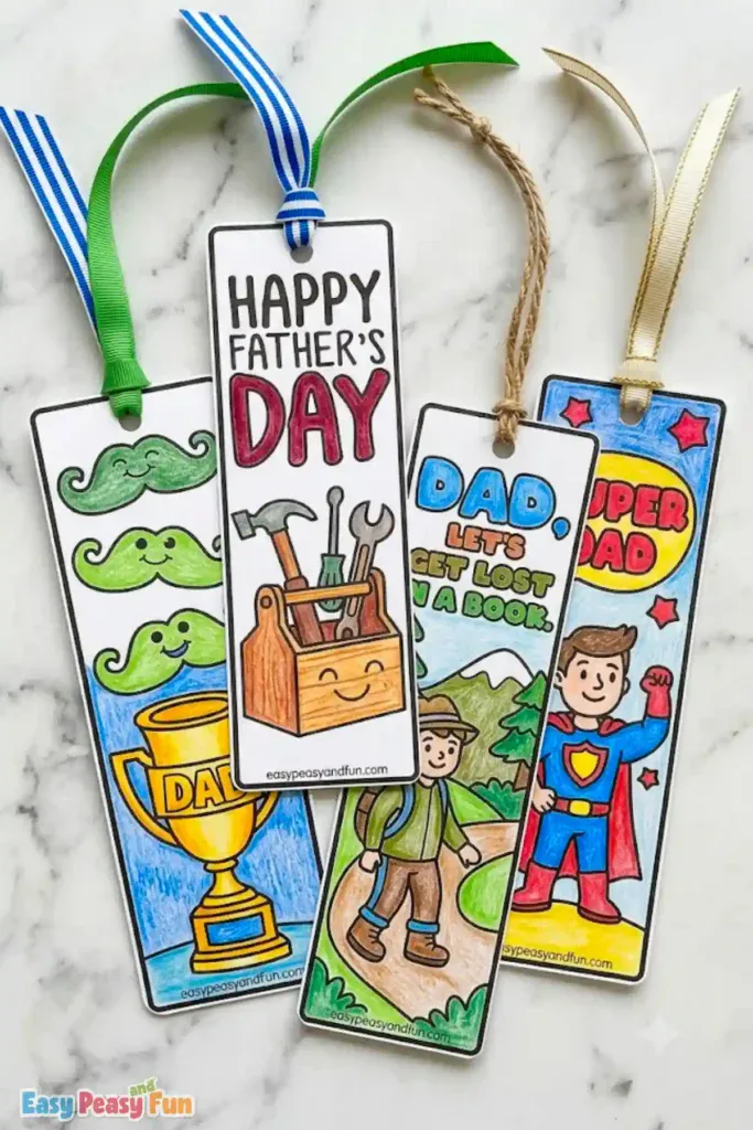 Four colored Father's Day bookmarks with ribbons featuring smiley mustaches with DAD trophy, Happy Father's Day toolbox, hiking dad "Let's Get Lost In A Book", and a caped Super Dad.