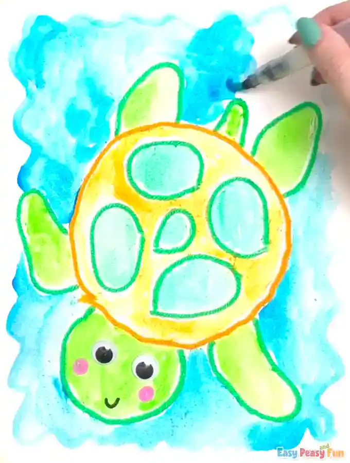 A brush sweeps blue watercolor around the turtle to create water.