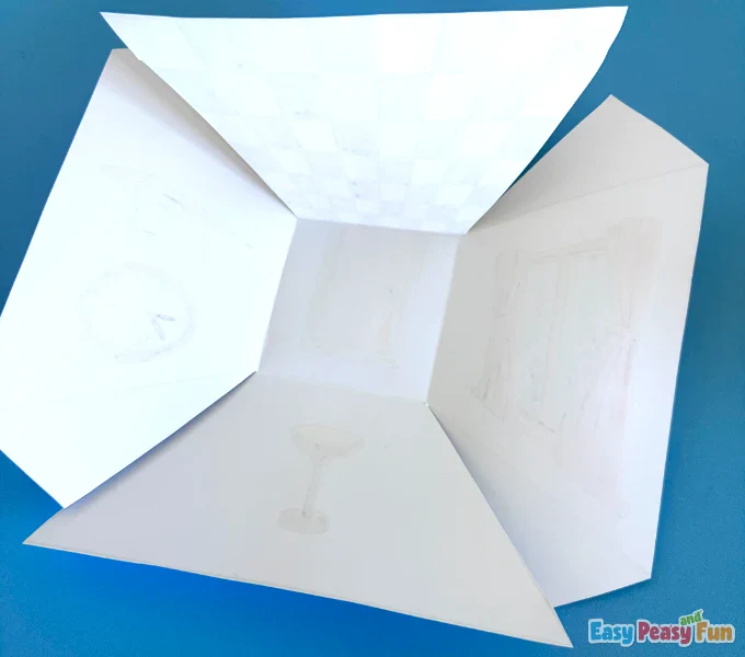 The paper template flipped over to show incisions made along the dashed lines on the back.