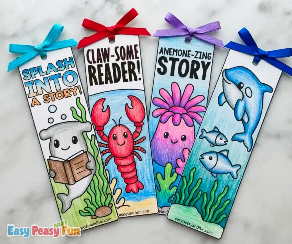 Four colored bookmarks featuring a hammerhead shark, crab, anemone, and dolphins with ribbon tops.