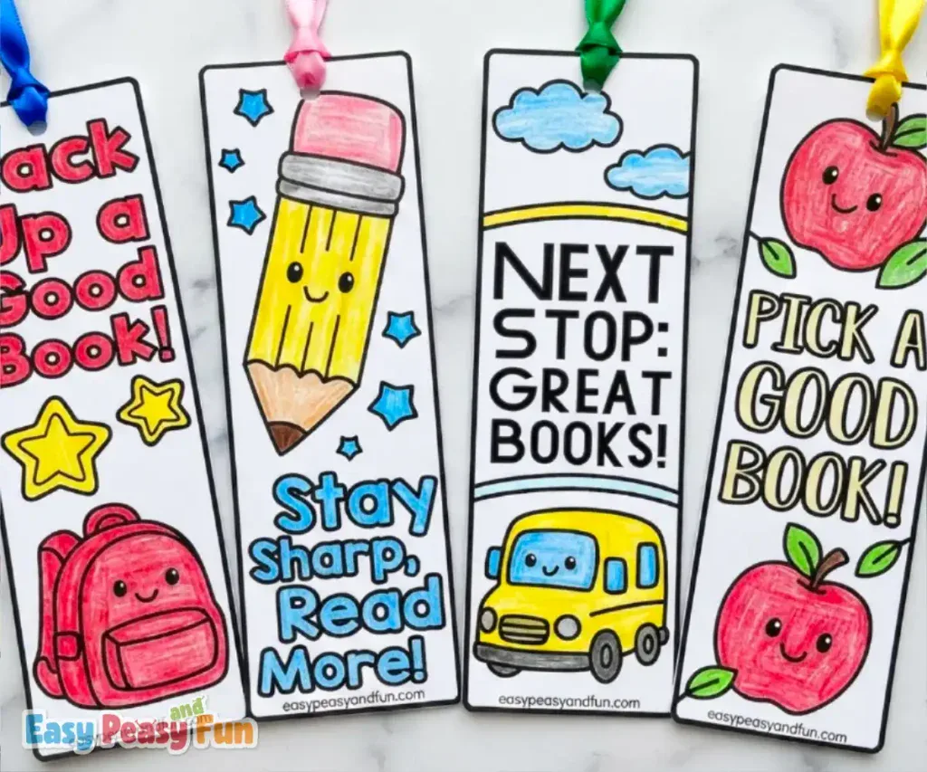 Four colorful back-to-school paper bookmarks displaying a red backpack, a smiling pencil, a school bus under clouds, and two red apples.