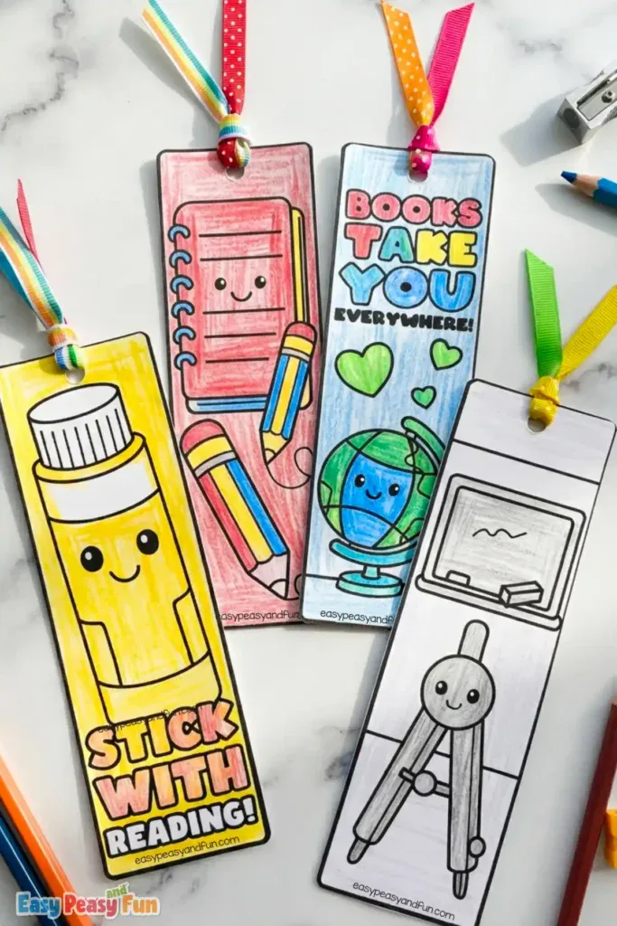 Four colorful paper bookmarks featuring a yellow glue stick, a red notepad with a pencil, a smiling globe, and a chalkboard illustration.
