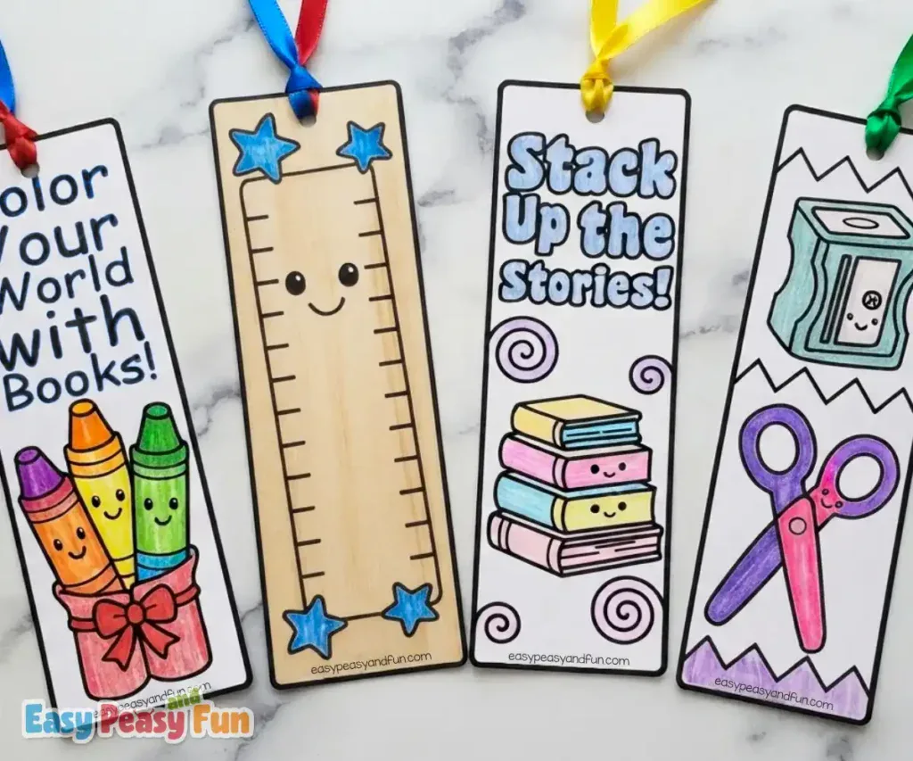 Four finished paper bookmarks showcasing colorful crayons, a smiling ruler, a stack of books, and a pencil sharpener with scissors.