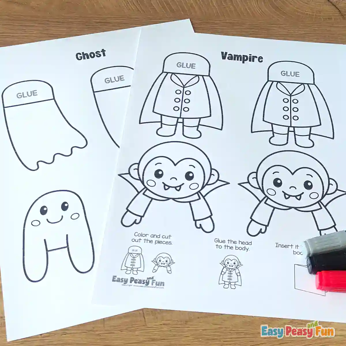 Two printed paper templates featuring a ghost and a vampire outline next to colored markers on a wooden table.