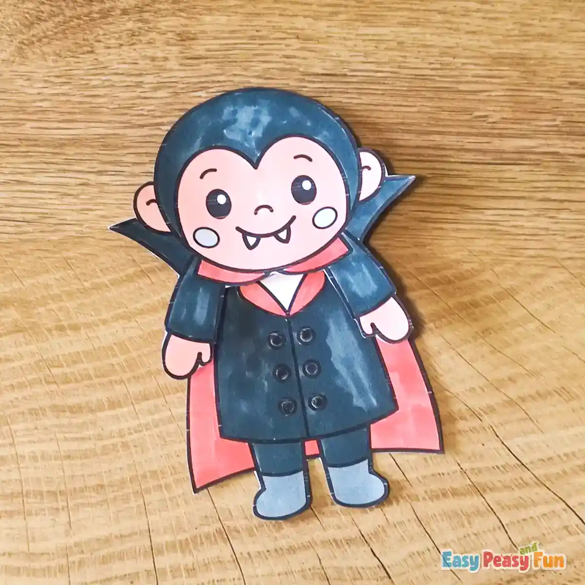 The vampire head piece glued securely onto the body piece, creating a complete character figure.