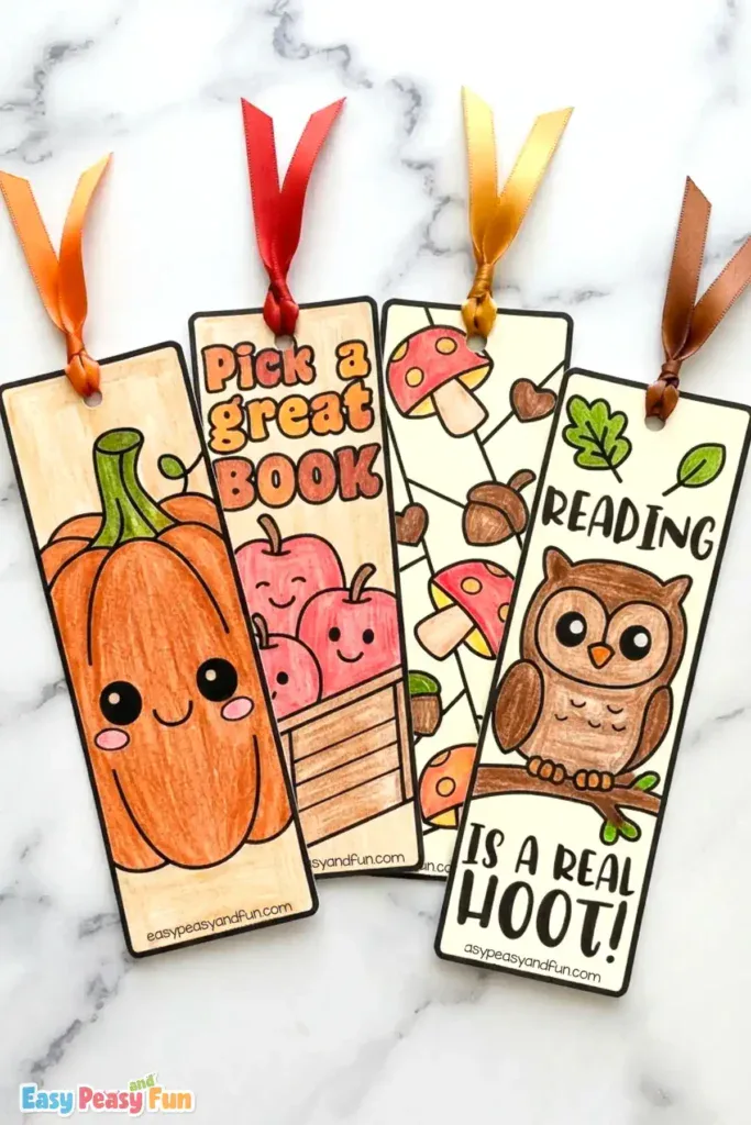 Four colored bookmarks displaying a pumpkin, apples in a crate, mushrooms with acorns, and an owl.