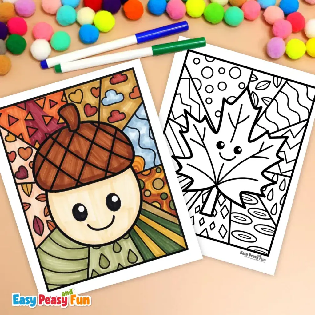 Two markers and colorful pom-poms resting above two fall pop art coloring pages, one featuring a colored acorn and the other a blank maple leaf design.
