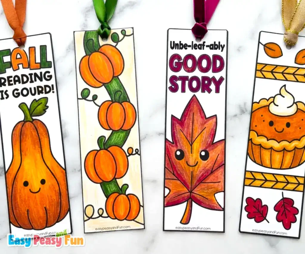 Four colored bookmarks displaying a squash, a pumpkin vine, a smiling leaf, and a pie.