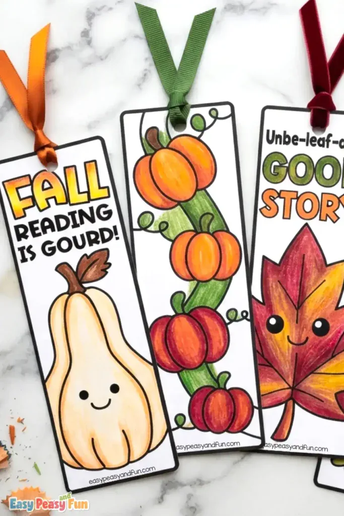 Three colored bookmarks featuring a smiling gourd, a twisting pumpkin vine, and a maple leaf.