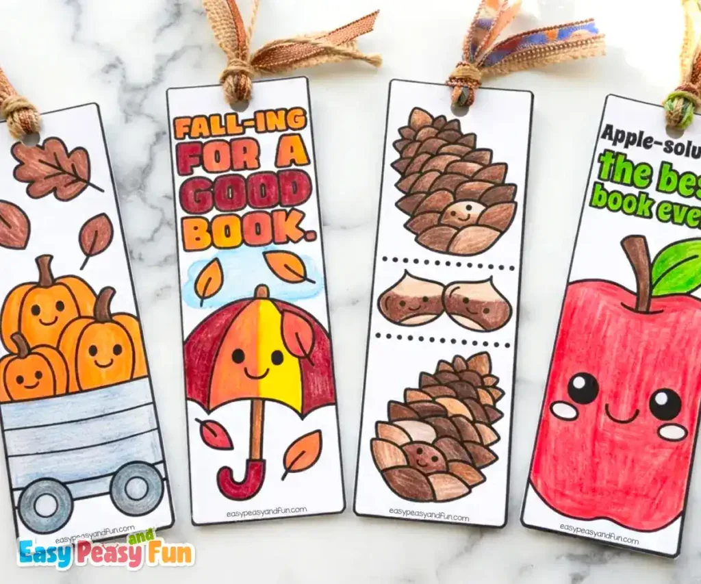 Four colored bookmarks showing a wagon with pumpkins, an umbrella in leaves, pinecones, and an apple.