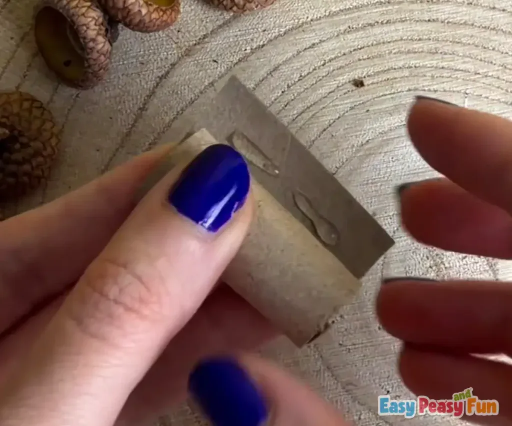 The cardboard tube is adjusted and rolled tighter to match the correct thickness for the mushroom stem.
