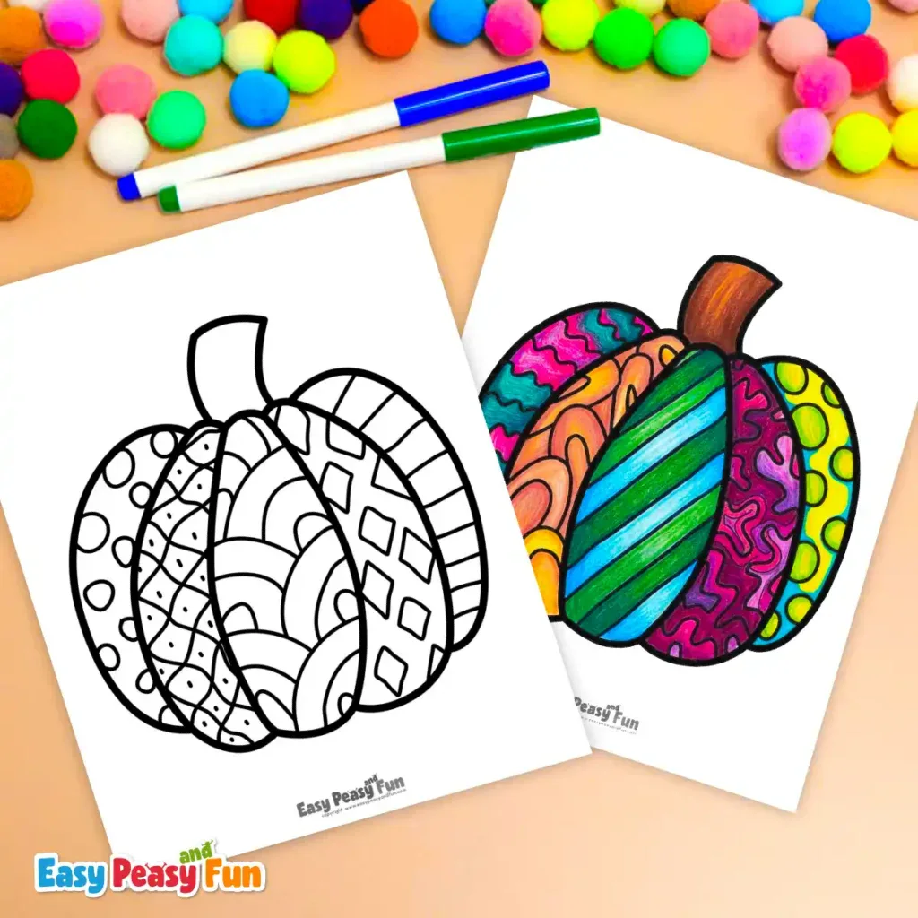 Two pumpkin coloring sheets with markers and colorful pom-poms on a flat surface.