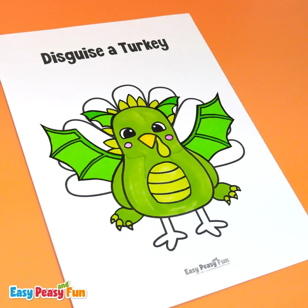 A paper turkey craft disguised as a green dragon, drawn with wings, back spikes, and scales on its belly.