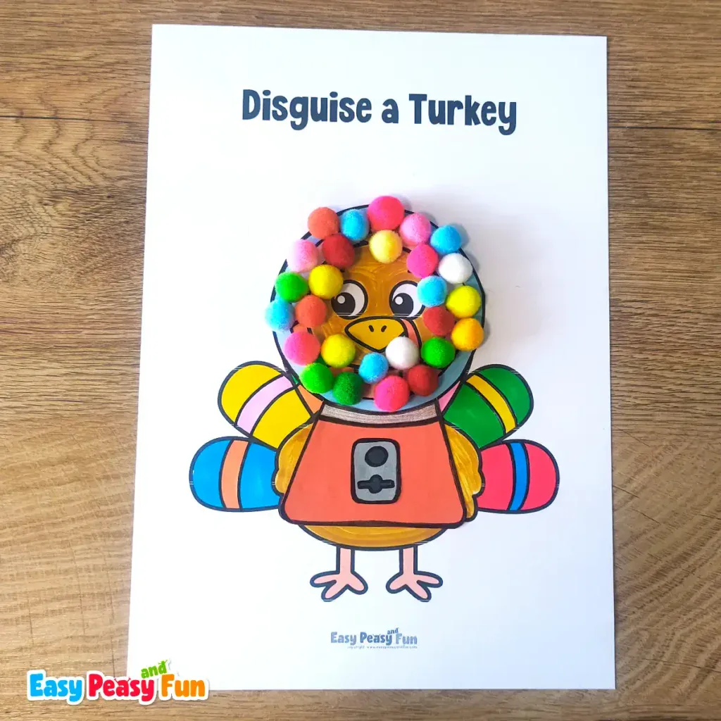 A paper turkey craft template disguised as a gumball machine featuring colorful pom-poms arranged inside a glass dome over an orange base.