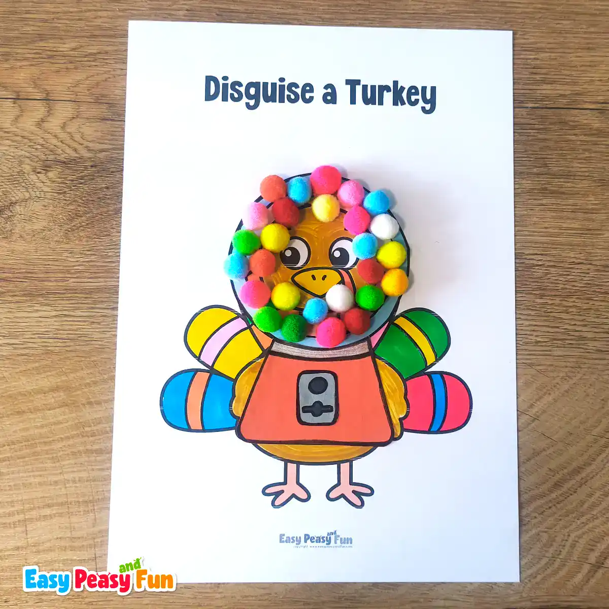A paper turkey craft template disguised as a gumball machine featuring colorful pom-poms arranged inside a glass dome over an orange base.