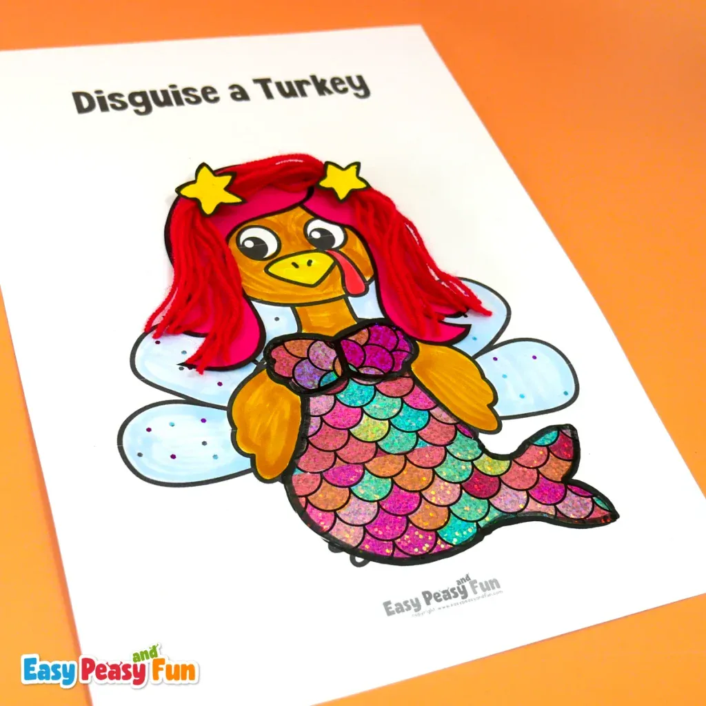 A paper turkey craft disguised as a mermaid, wearing red yarn hair, star hair clips, and a shiny, multicolored scale tail.