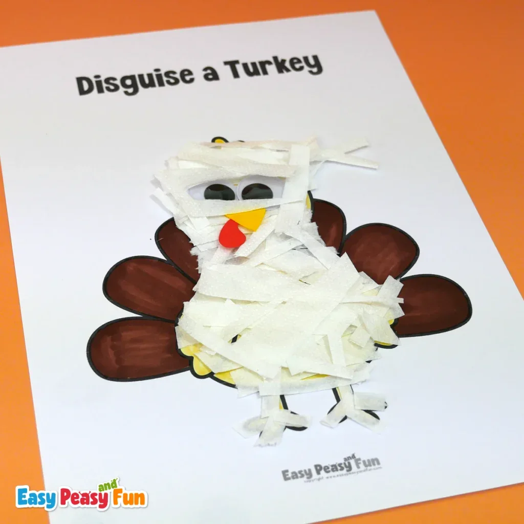 A paper turkey craft disguised as a mummy, covered with white paper strips and featuring large googly eyes.