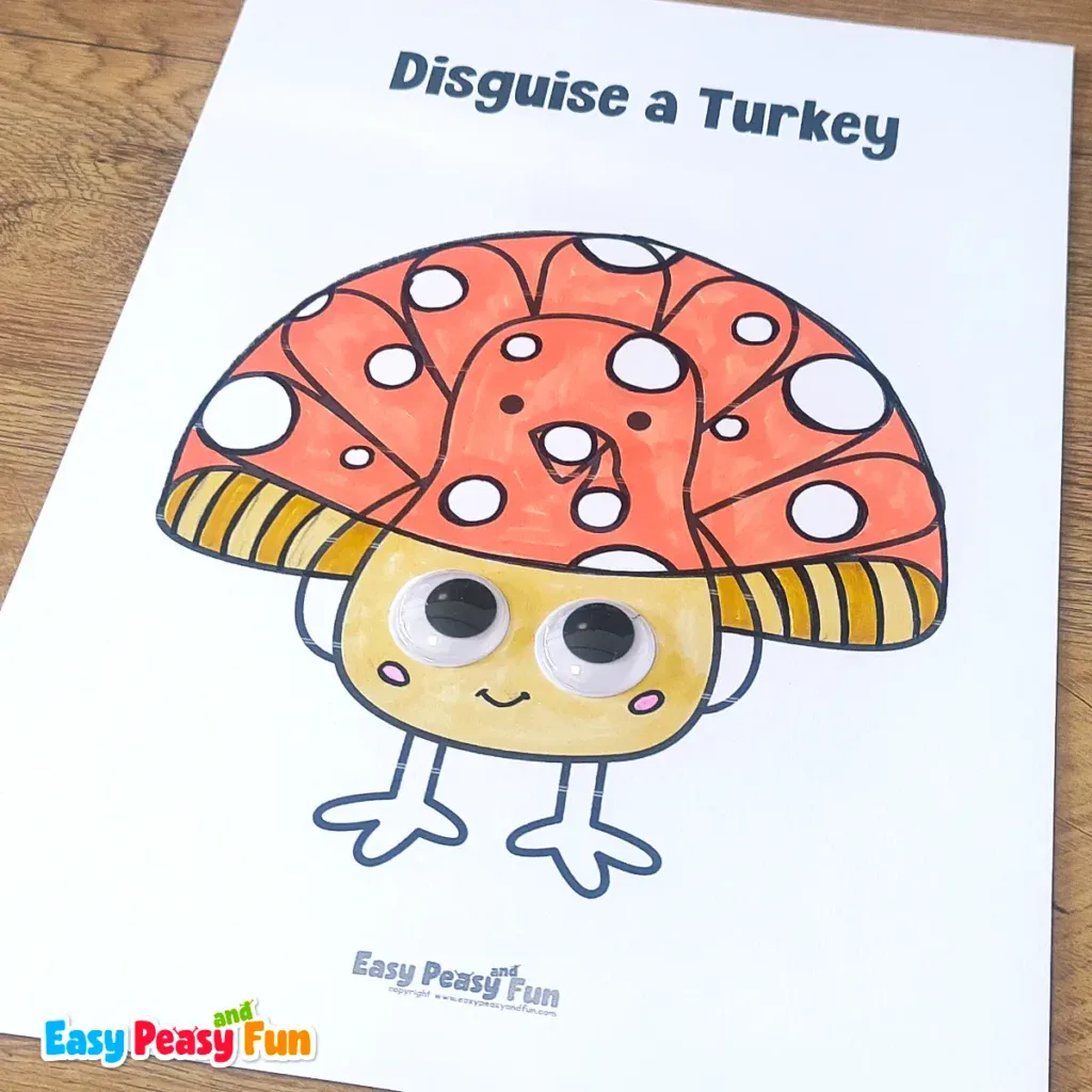 A paper turkey craft template disguised as a red and white spotted mushroom with googly eyes and a yellowish stem.