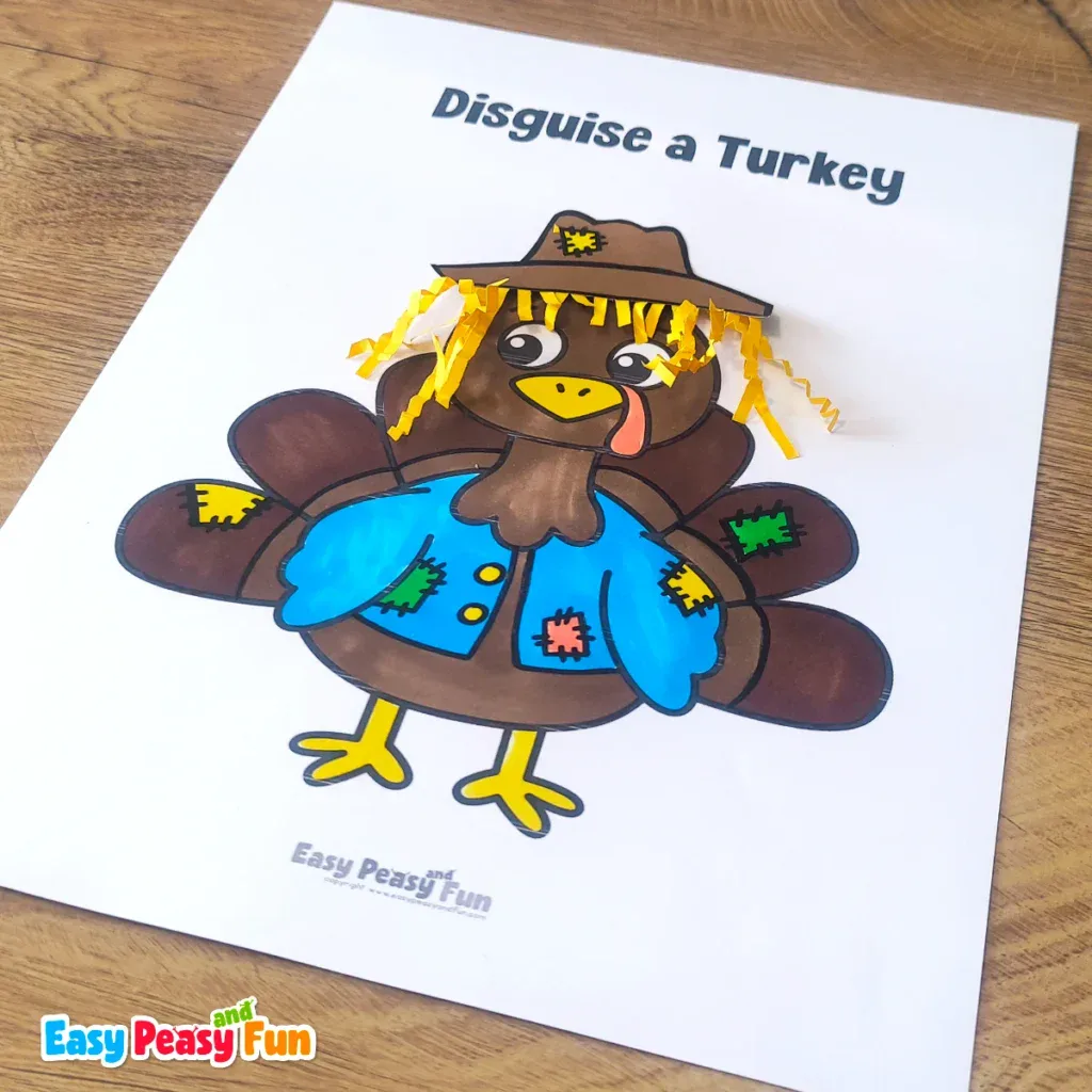 A paper turkey craft template disguised as a scarecrow wearing a brown hat with straw hair and a blue patched shirt.