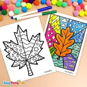 Two printed leaf coloring pages and markers arranged on a light surface.