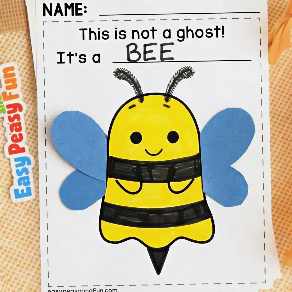 Yellow and black striped ghost craft with blue paper wings and antennae made to look like a bee.