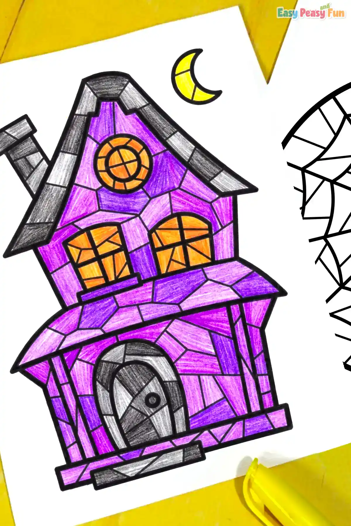 A close-up view of a hand-colored purple and grey haunted house mosaic coloring page styled with a yellow crescent moon.